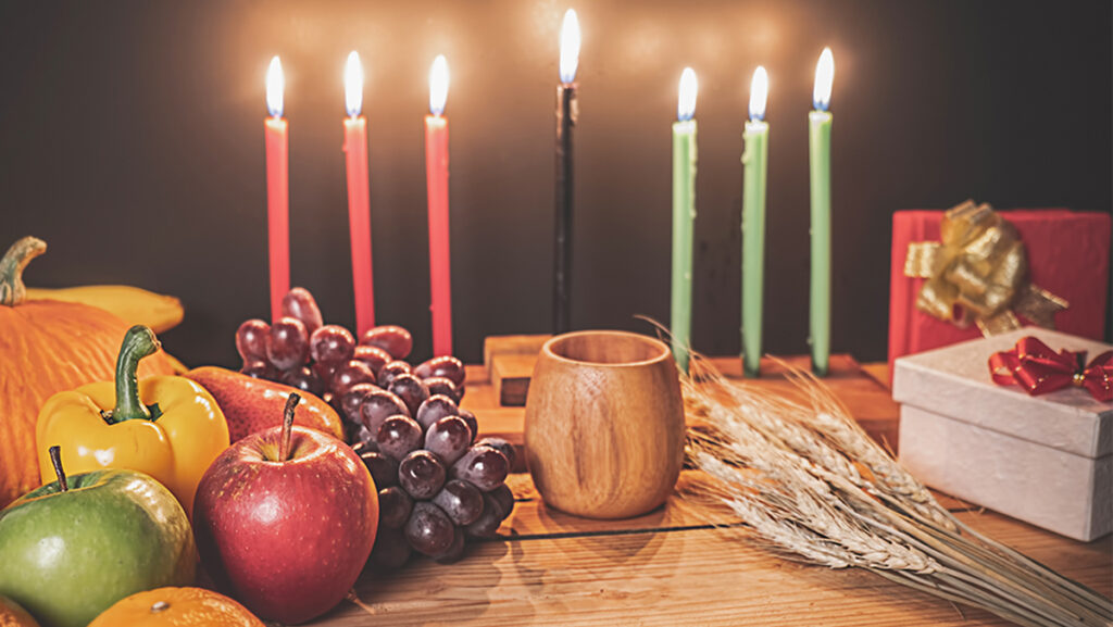 How to celebrate Kwanzaa with a candles, fruit and presents.