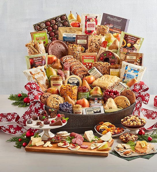 A photo of last-minute gift ideas with a basket overflowing with cookies, cheese, meat, crackers and fruit