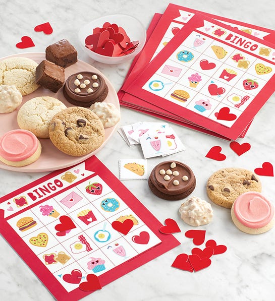 A photo of gifts for couples with a bingo game and a plate of cookies.