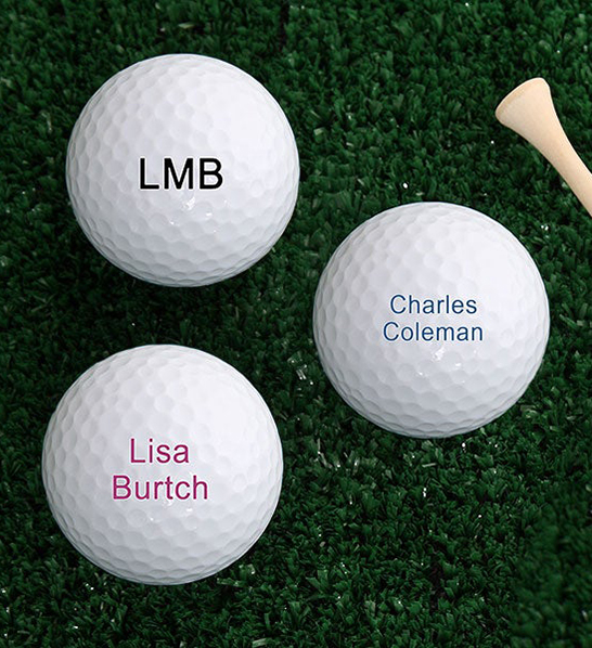 A photo of gifts for couples with three golf balls with personalized names on them.