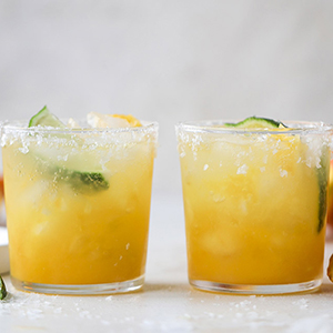 Two HoneyBell margaritas on a counter.