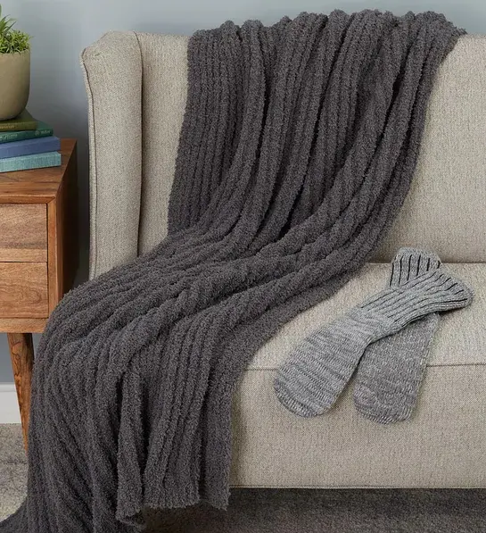 Valentine's Day gifts for him with a blanket draped over a bench with a pair of socks next to it.