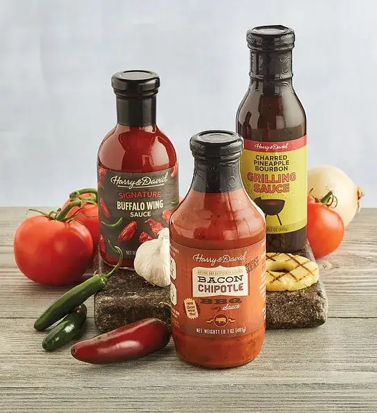 Valentine's Day gifts for him with three types of grilling sauces surrounded by ingredients.