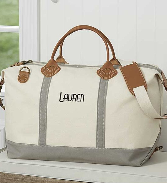 A photo of gifts for women with a personalized canvas duffel bag.