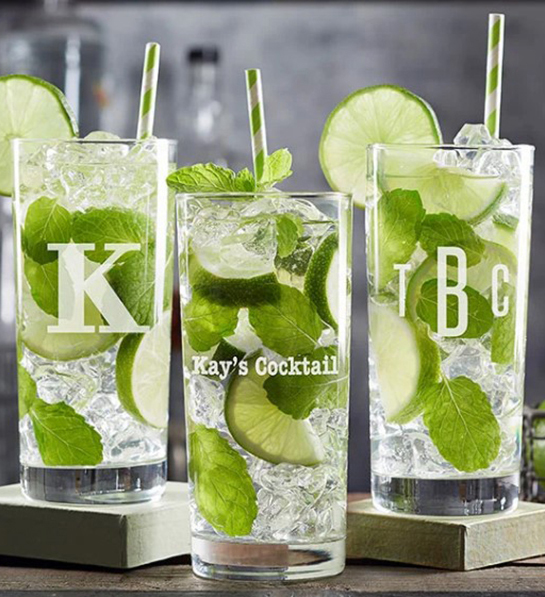 A photo of gifts for men with three personalized glasses monogrammed with initials and full of ice, liquid, lime and mint.