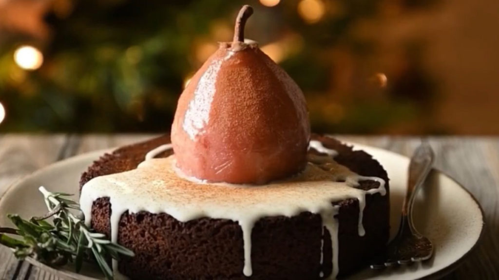 A photo of spice cake with a poached pear on top
