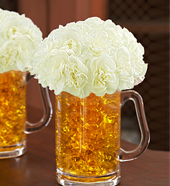 A photo of St. Patrick's Day celebrations with beer mugs full of white flowers.