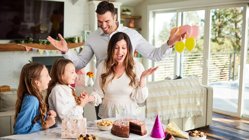 This is an image of April Birthdays and a family surprising the mom with a cake.