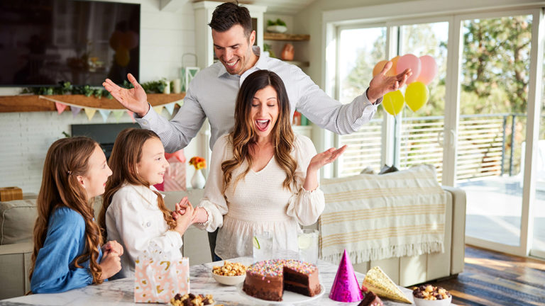 This is an image of April Birthdays and a family surprising the mom with a cake.