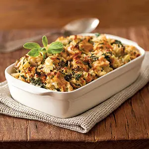A photo of April recipes with an artichoke mac and cheese in a casserole dish