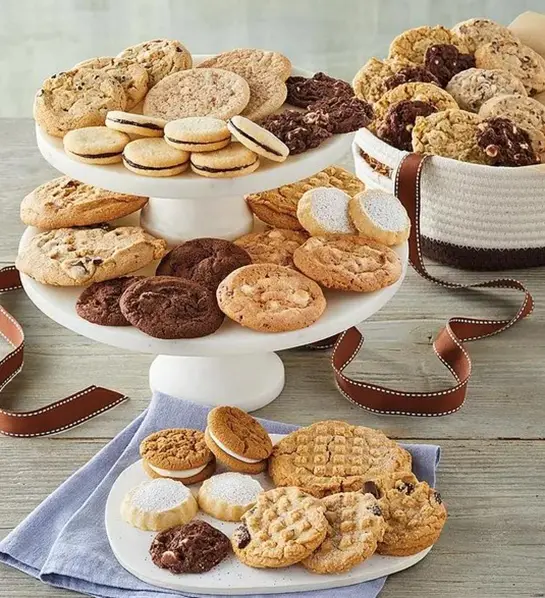 A photo of birthday gifts for sister with a collection of cookies on platters and plates