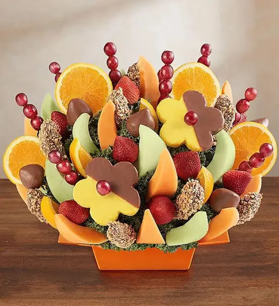 A photo of birthday gifts for sister with a large fruit bouquet with chocolate-covered fruit