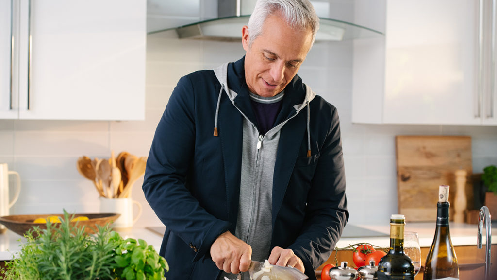 A photo of Chef Zakarian chopping onions in a kitchen
