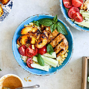 A photo of chicken recipes with a bowl of grilled peaches and chicken with vegetables