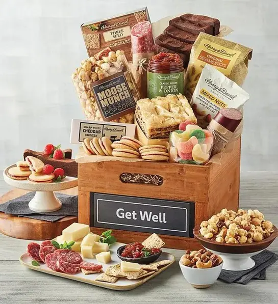 A photo of get well soon with a gift box full of food