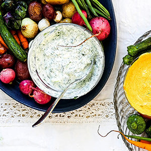 A photo of spring recipes with a platter of roasted vegetables and yogurt dip