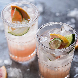 A photo of spring recipes with two glasses of grapefruit paloma cocktails