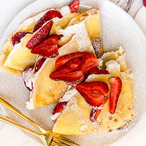 A photo of spring recipes with a plate of strawberry crepes