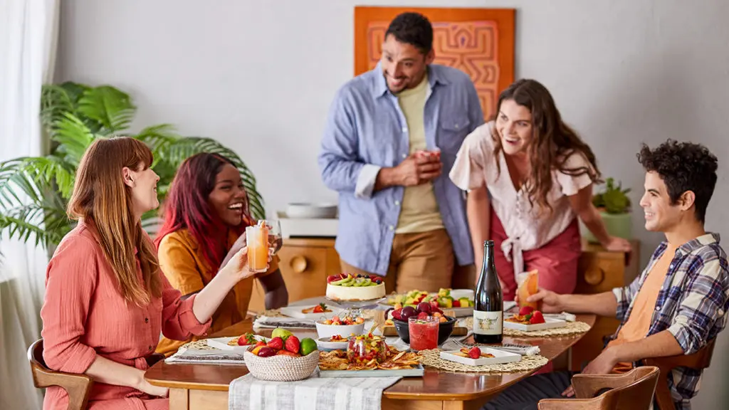 A photo of spring self-care ideas with a group of friends having breakfast and laughing.