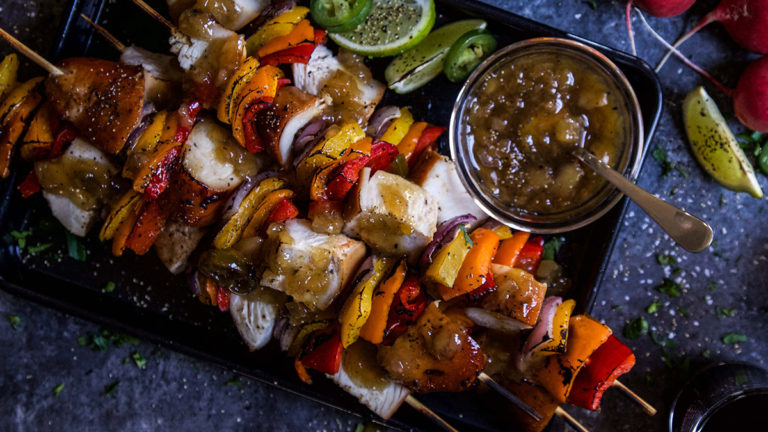 A photo of teriyaki chicken with a plate of chicken skewers.