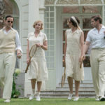 A photo of Downton Abbey party with a group of people walking on a lawn outside a large house