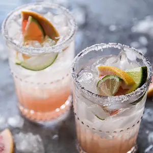 A photo of may recipes with two glasses of grapefruit paloma cocktails
