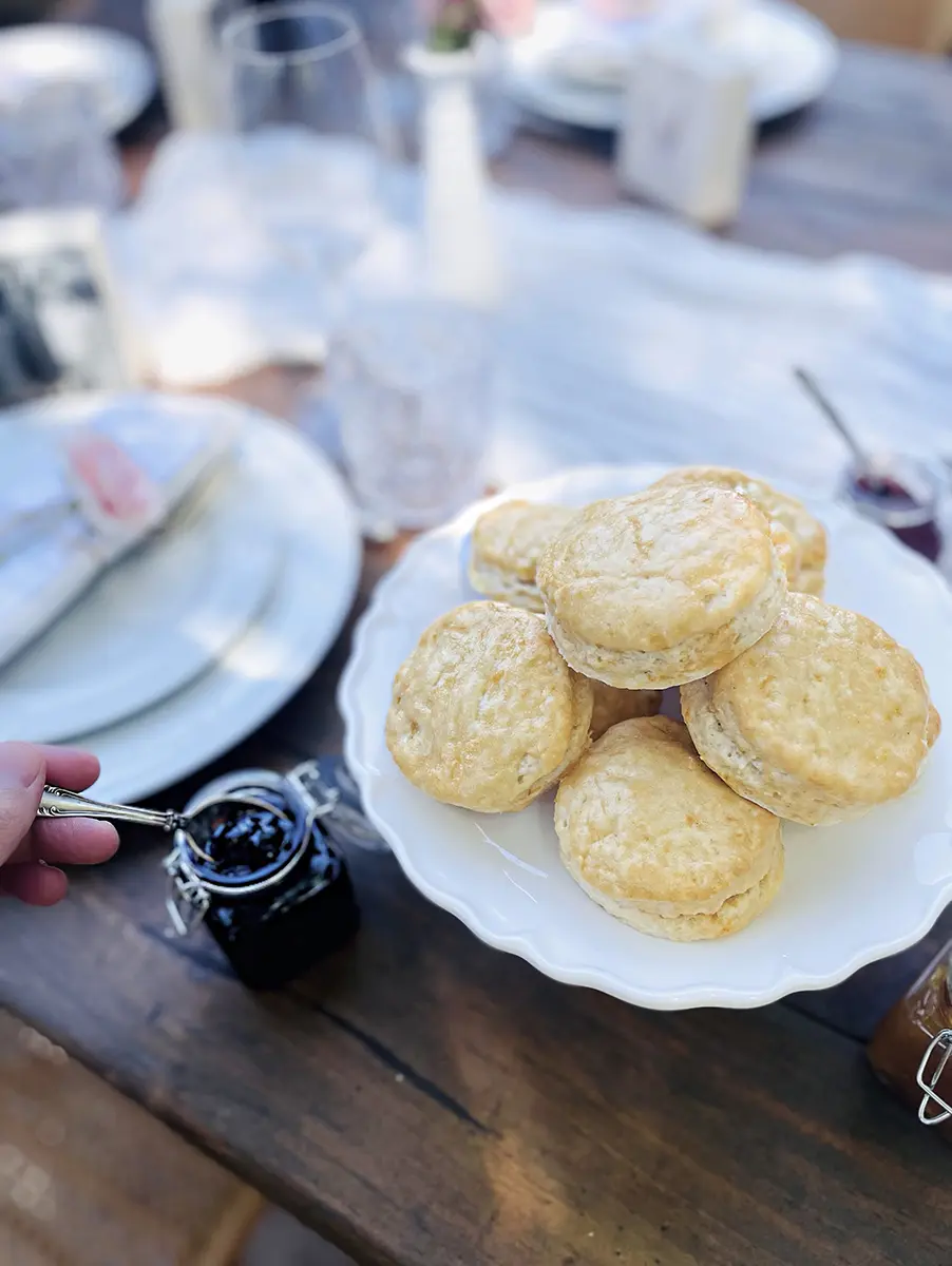 A photo of mother's day brunch recipes with a plate of scones on a table.