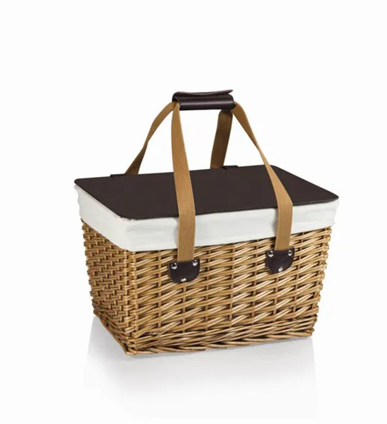 A photo of picnic with a wicker basket
