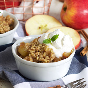 A photo of slow cooker recipes with a bowl of apple crisp and ice cream