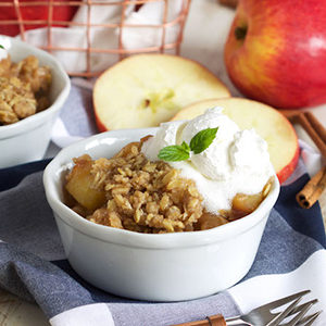 A photo of slow cooker recipes with a bowl of apple crisp and ice cream