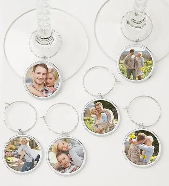 A photo of wine gifts for mom with several personalized wine stem charms with photos of a married couple