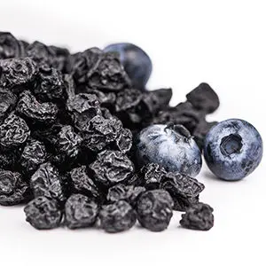 A photo of dried fruit with a heap of dried blueberries
