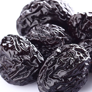 A photo of dried fruit with several prunes