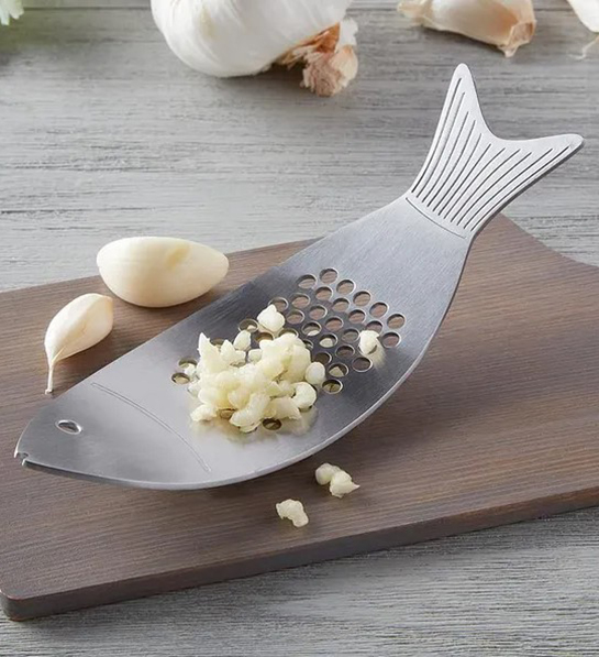 A photo of graduation gift ideas with a fish shaped garlic press