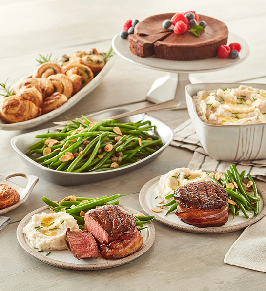 A photo of graduation gift ideas with a table full of gourmet dishes.