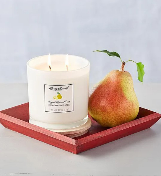 A photo of graduation gift ideas with a pear next to a candle