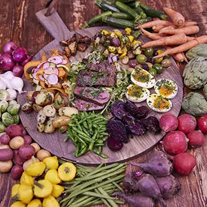A photo of june recipes with a plate of steak surrounded by vegetables