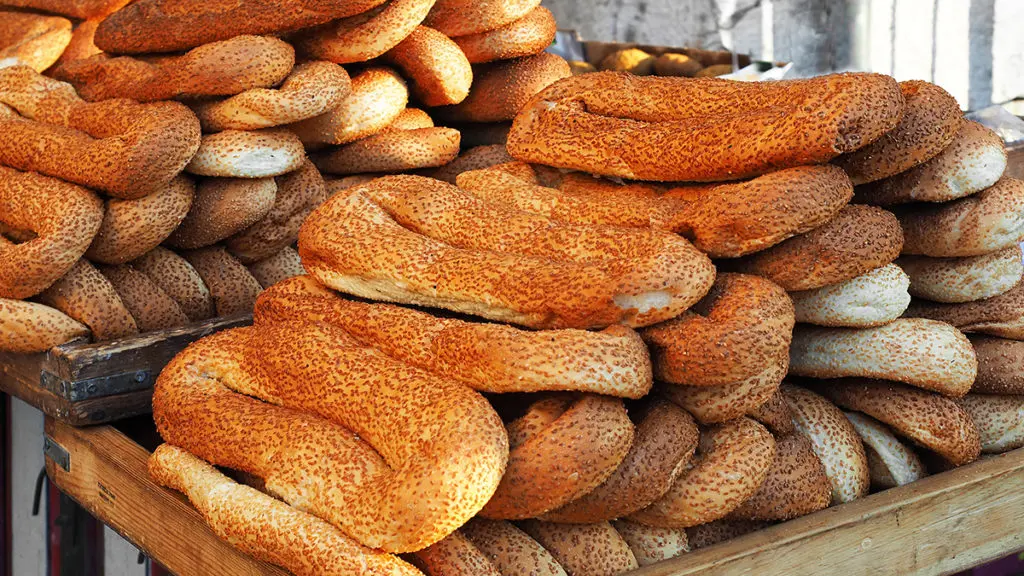 A photo of origin of the bagel with a stack of Jerusalem bagels on a table