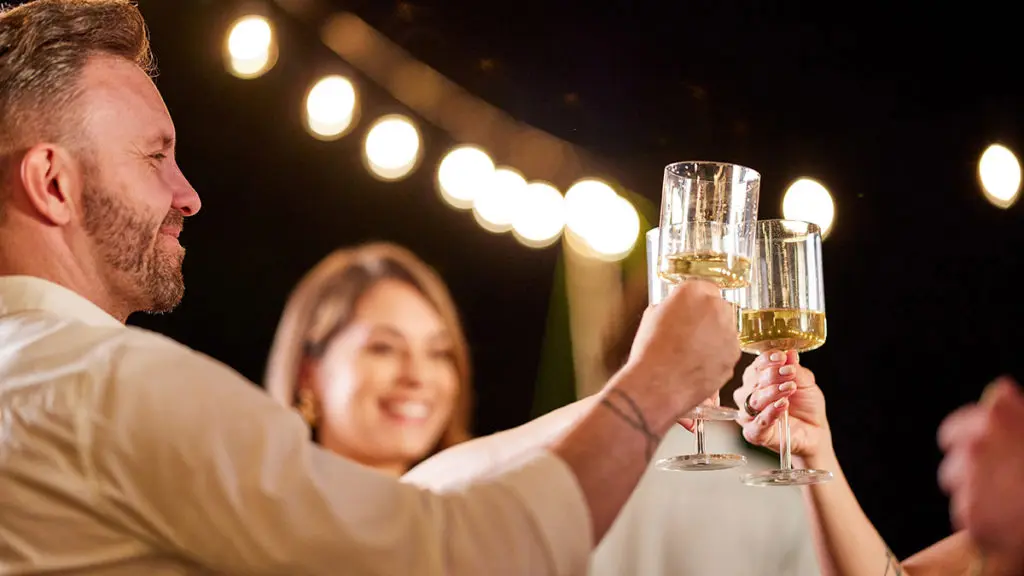 A photo of pinot gris in glasses that people are raising together