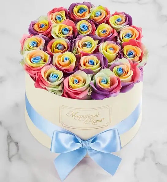 A photo of pride month gifts with a bouquet of rainbow colored roses