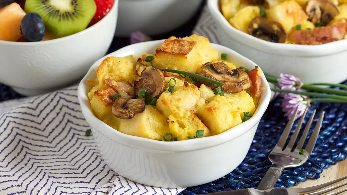 A photo of strata with mushroom, bacon and English muffins
