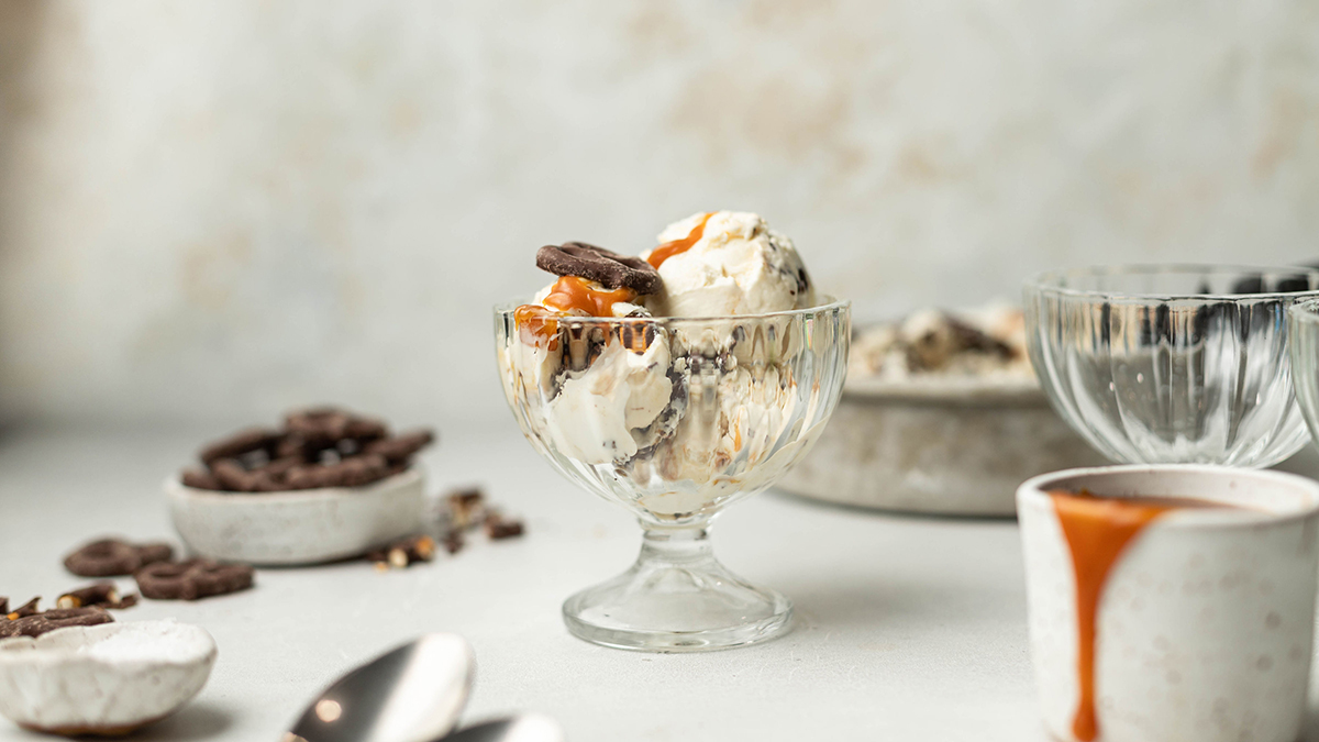 Photo of caramel ice cream with chocolate covered pretzels in a bowl.