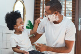dad jokes African American father and little son spend time together