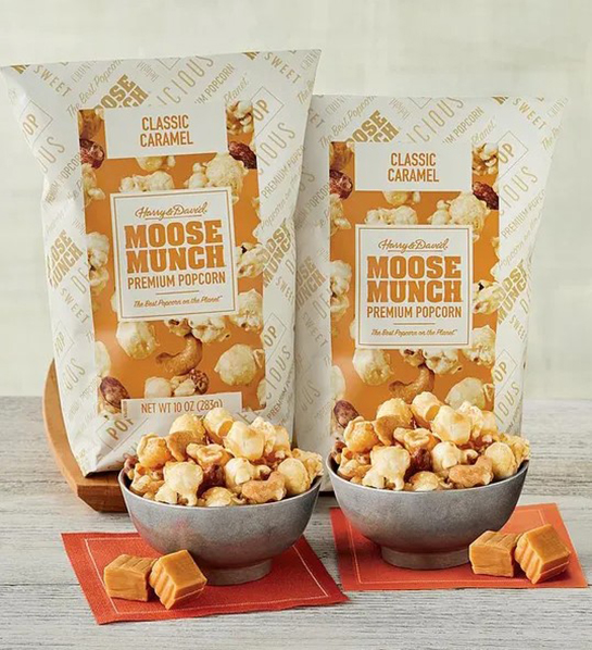 A photo of father's day gift guide with two bags of moose munch popcorn behind bowls of the same popcorn