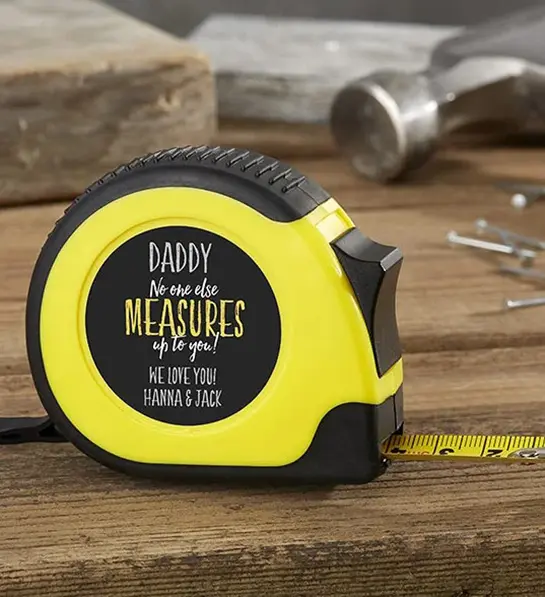 A photo of father's day gift guide with a customized tape measure