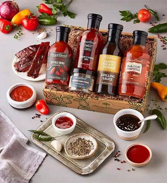 Photo of grilling gifts with a box of bottles of barbecue sauce in a box.