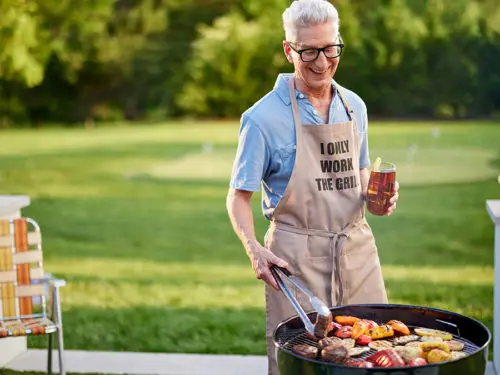 Photo of grilling gifts with a man grilling meat and vegetables outside.