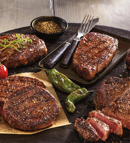 Photo of grilling gifts with a platter of several different cuts of grilled meat.