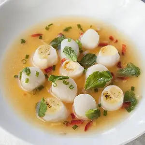 Photo of july recipes with a closeup of scallop ceviche in a bowl.
