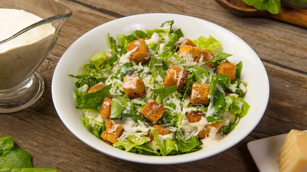 Photo of salads with a caesar salad in a bowl